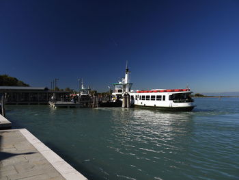 Ship in sea against clear blue sky