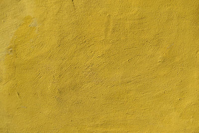 Yellow concrete background texture with scraps