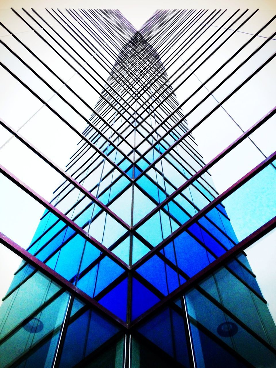 low angle view, architecture, built structure, building exterior, modern, office building, skyscraper, tall - high, city, glass - material, tower, building, sky, reflection, tall, day, no people, directly below, glass, outdoors