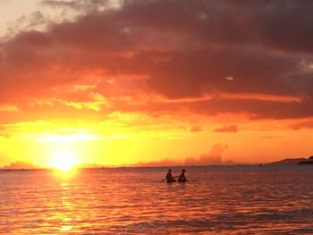 Silhouette of boat in sea during sunset