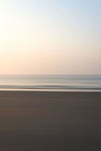 Scenic view of sea against clear sky during sunset