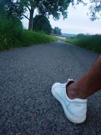 Low section of man on road in city