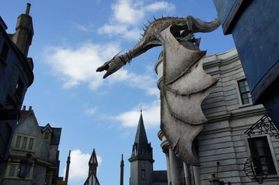 Low angle view of statue in front of church