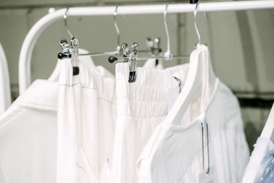 Sustainable fashion, slow fashion. close up shot of clothing rack with natural tones clothes