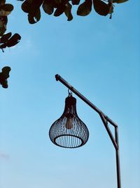 Low angle view of lamp hanging against clear sky