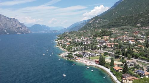 High angle view of city by sea against sky