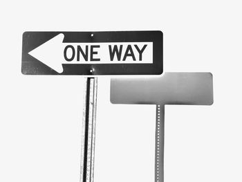 Low angle view of road sign against white background