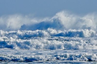 Scenic view of ocean waves against sky