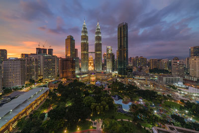 View of cityscape against cloudy sky