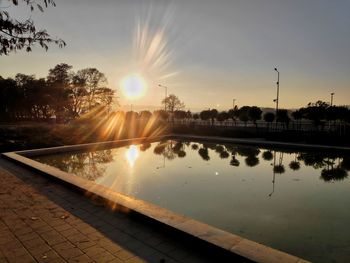 Scenic view of swimming pool against sky during sunset