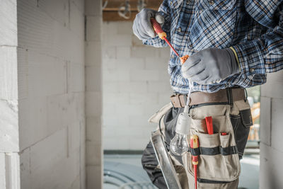 Rear view of man standing in workshop