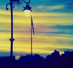 Low angle view of street light against sky at sunset