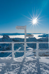 Snow covered field against sky