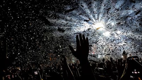 People enjoying illuminated music concert at night