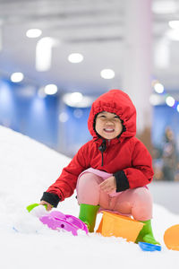 Portrait of cute girl playing with christmas snow