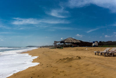 Scenic view of beach by sea against sky