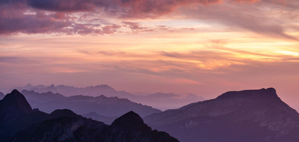 Scenic view of silhouette mountains against sky during sunset