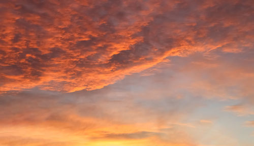 Beautiful panorama of orange and yellow clouds at sunrise and sunset in a blue sky