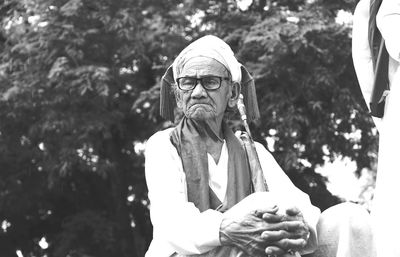 Low angle view of man sitting on sculpture
