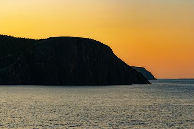 Scenic view of sea against orange sky