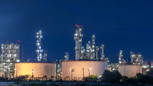 Oil and gas refinery plant at night, global business energy logistic transportation, oil and gas