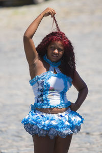 Midsection of woman standing at beach