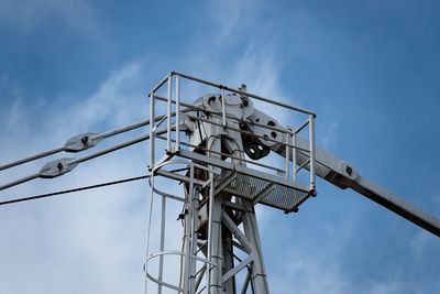 Low angle view of electricity pylon against sky