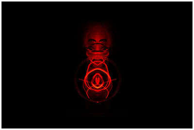 Close-up of light bulb over black background