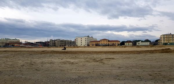 Buildings on beach against sky in city