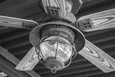 Low angle view of illuminated chandelier hanging from ceiling