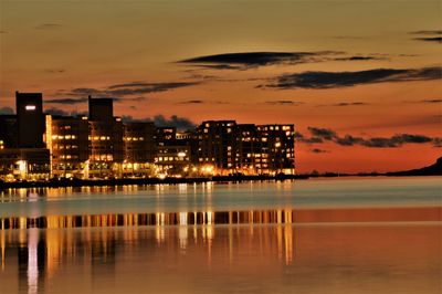 Illuminated city at sunset