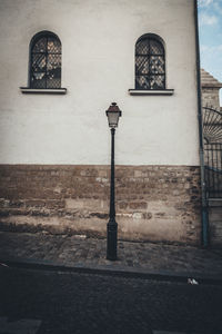 Lamp amidst street and building