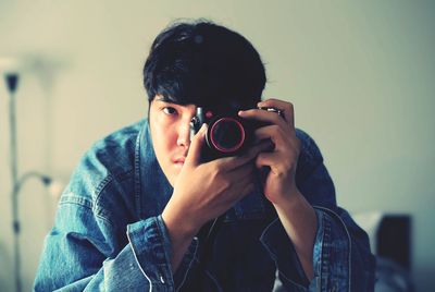 Young woman photographing through camera