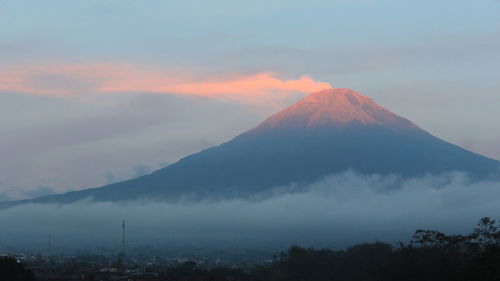 Scenic view of snowcapped mountain against cloudy sky