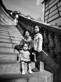 Siblings standing on steps