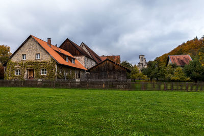 Houses on field against sky