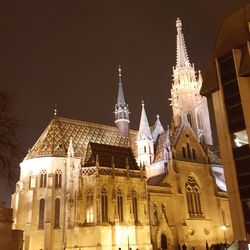 Low angle view of illuminated cathedral against sky at night