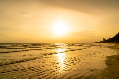 Scenic view of beach against sky during sunset