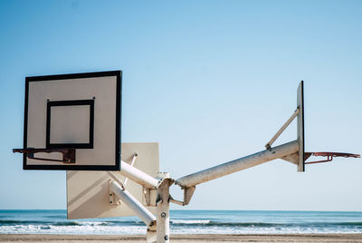 Basketball hoops against sea at beach