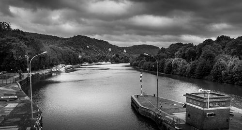 Scenic view of river by mountains against sky. black and white picture.