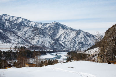 Scenic view of snowcapped mountains and lake against sky
