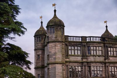 Low angle view of church against cloudy sky