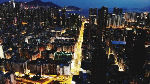 High angle view of illuminated buildings in city at night