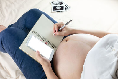 High angle view of woman using mobile phone