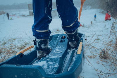 Low section of person skiing on snow