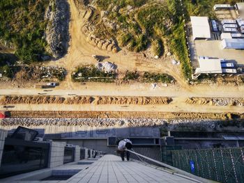 High angle view of worker climbing on building