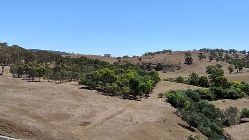 Scenic view of landscape against clear blue sky