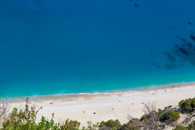 Scenic view of beach against blue sky