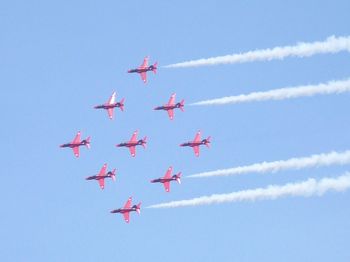 Low angle view of airshow in sky