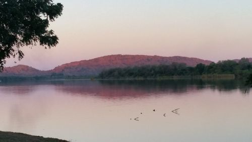 Scenic view of lake against sky during sunset